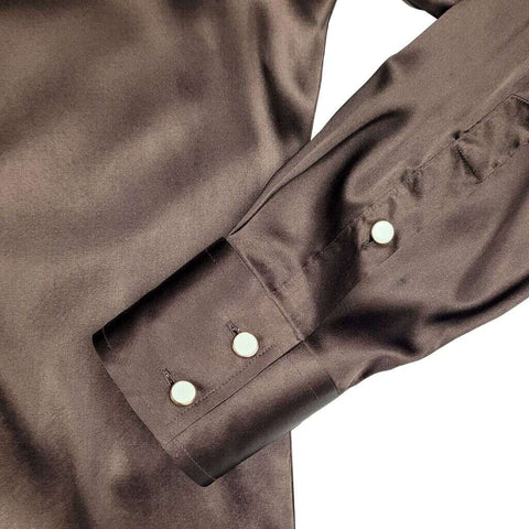 close up of a cuff on a long sleeve brown silk dress shirt for men