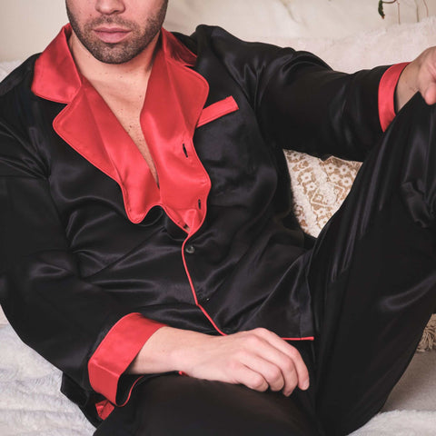 man sitting on a sofa wearing silky smooth 100% silk pajamas from 1000 Kingdoms