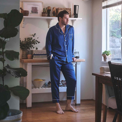 man standing in the kitchen wearing midnight blue silk pajamas from 1000 kingdoms