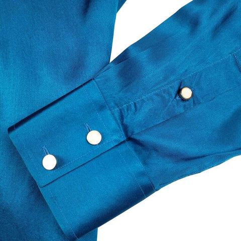 close up shot of the cuff on a turquoise blue long sleeve silk shirt for men